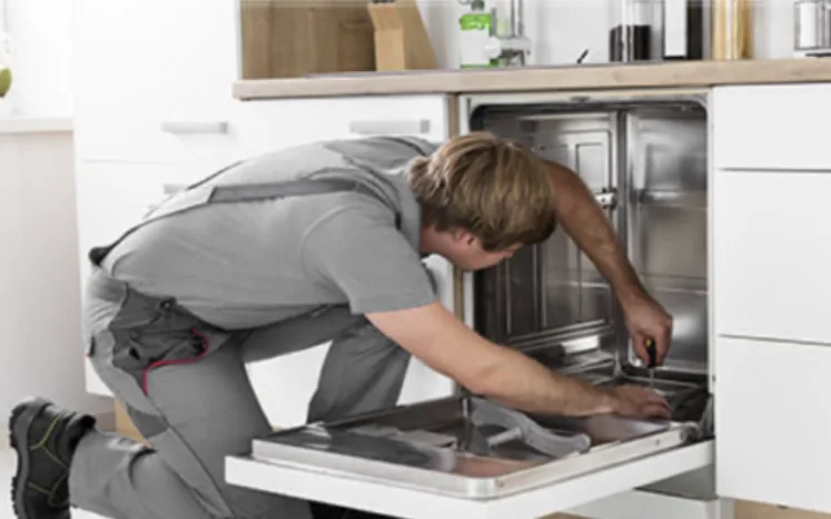 Engineer fixing an integrated dishwasher